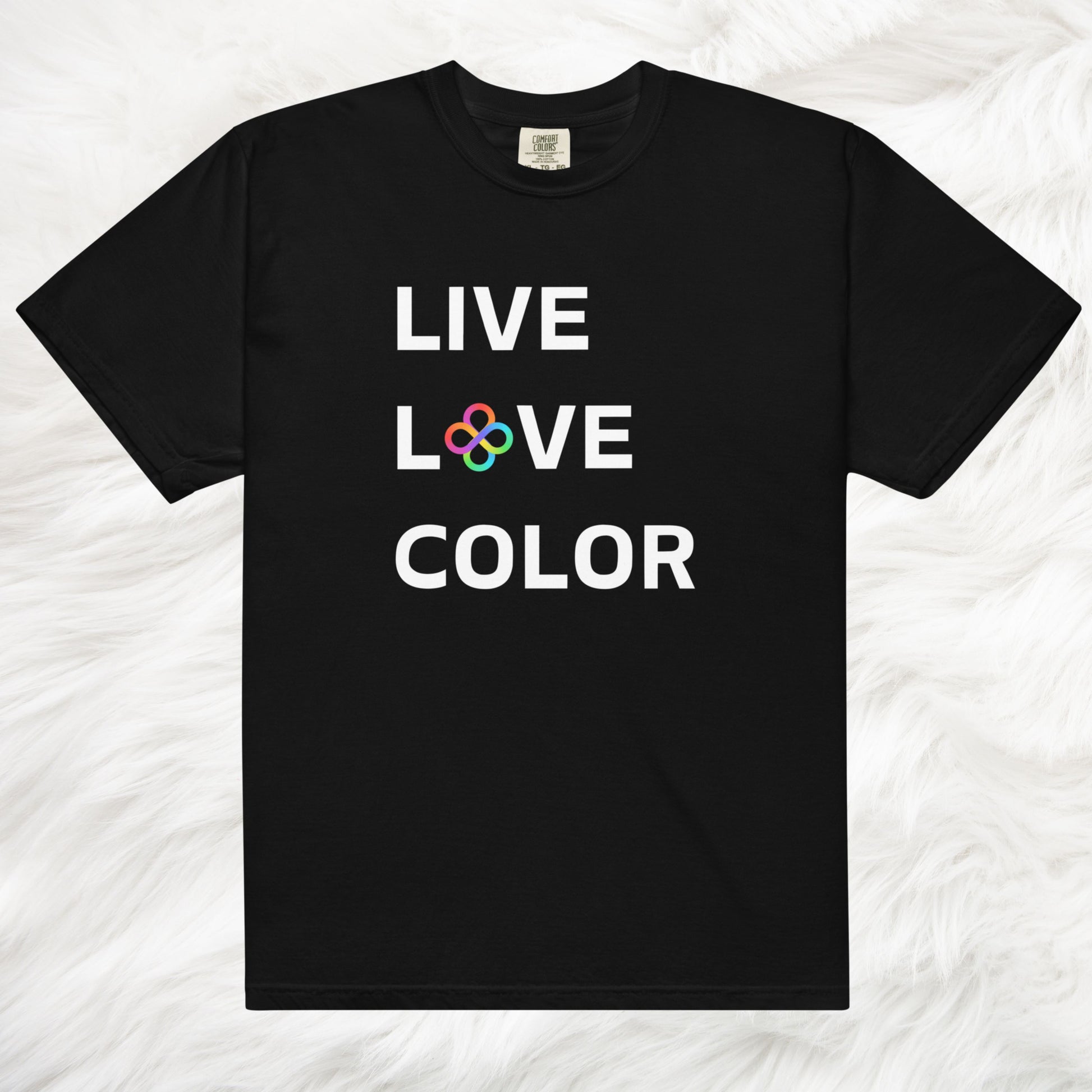 Black color tshirt with white bold print that says LIVE LOVE COLOR. The letter O in the word LOVE has been replaced with rainbow infinity symbols.