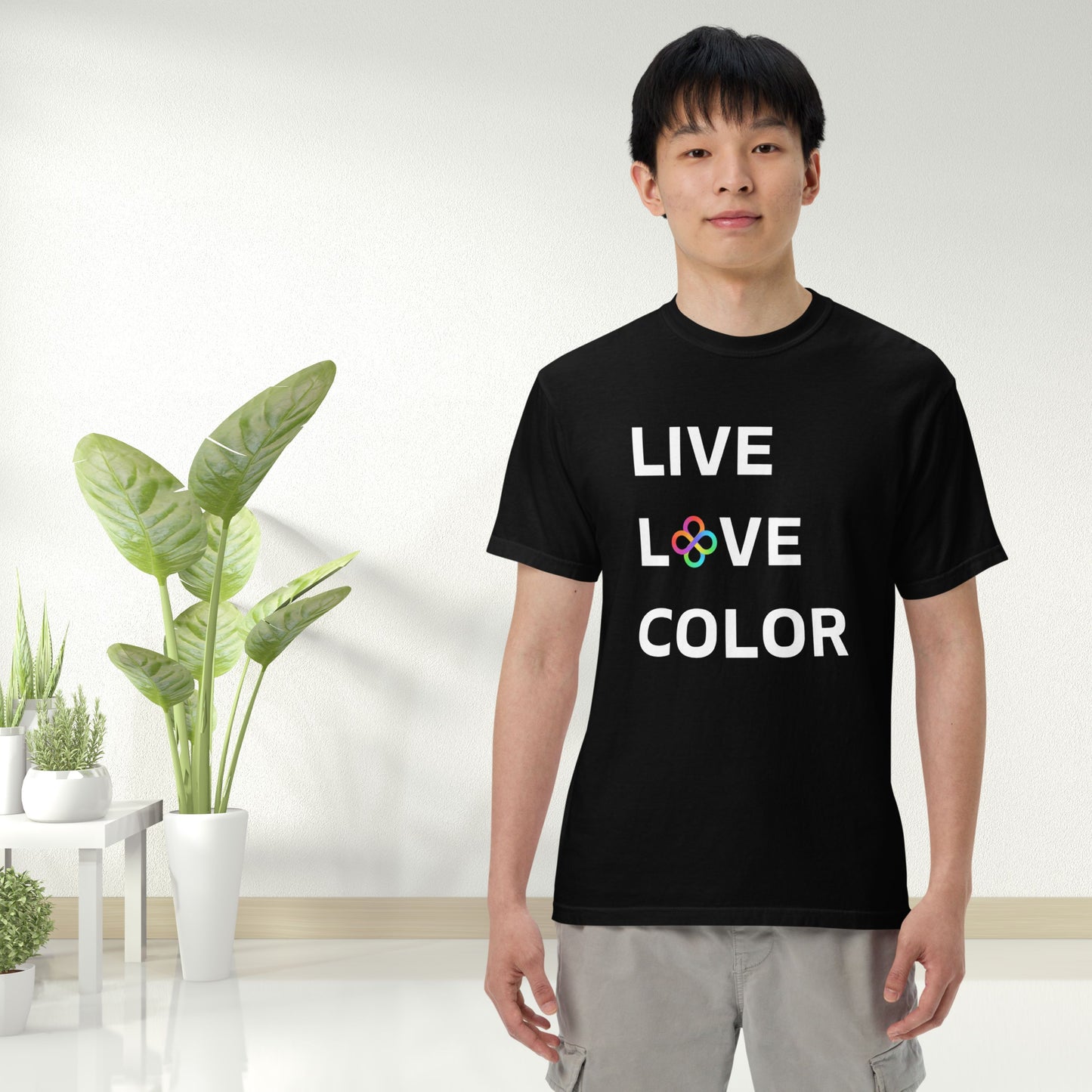 Black color tshirt with white bold print that says LIVE LOVE COLOR. The letter O in the word LOVE has been replaced with rainbow infinity symbols.