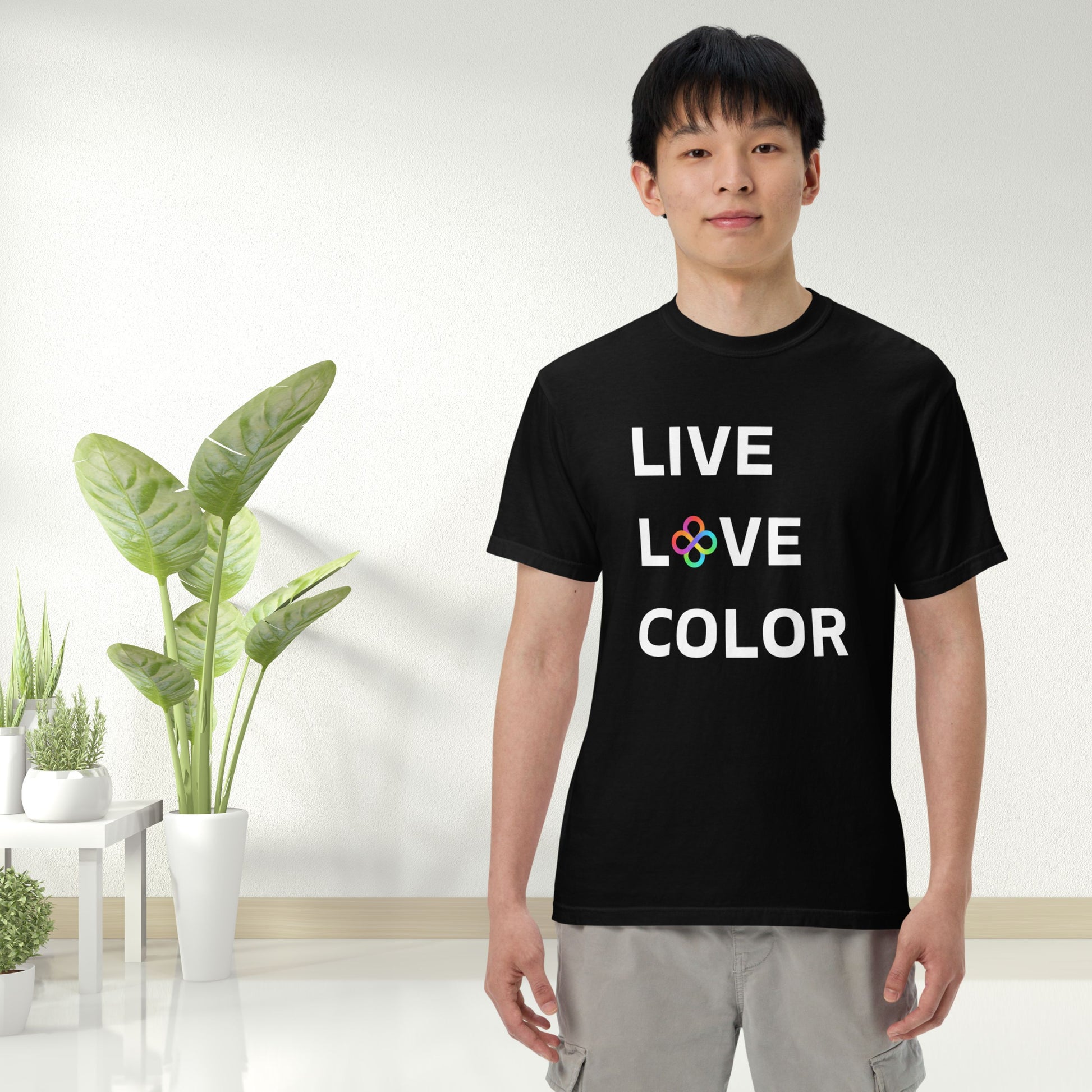 Black color tshirt with white bold print that says LIVE LOVE COLOR. The letter O in the word LOVE has been replaced with rainbow infinity symbols.