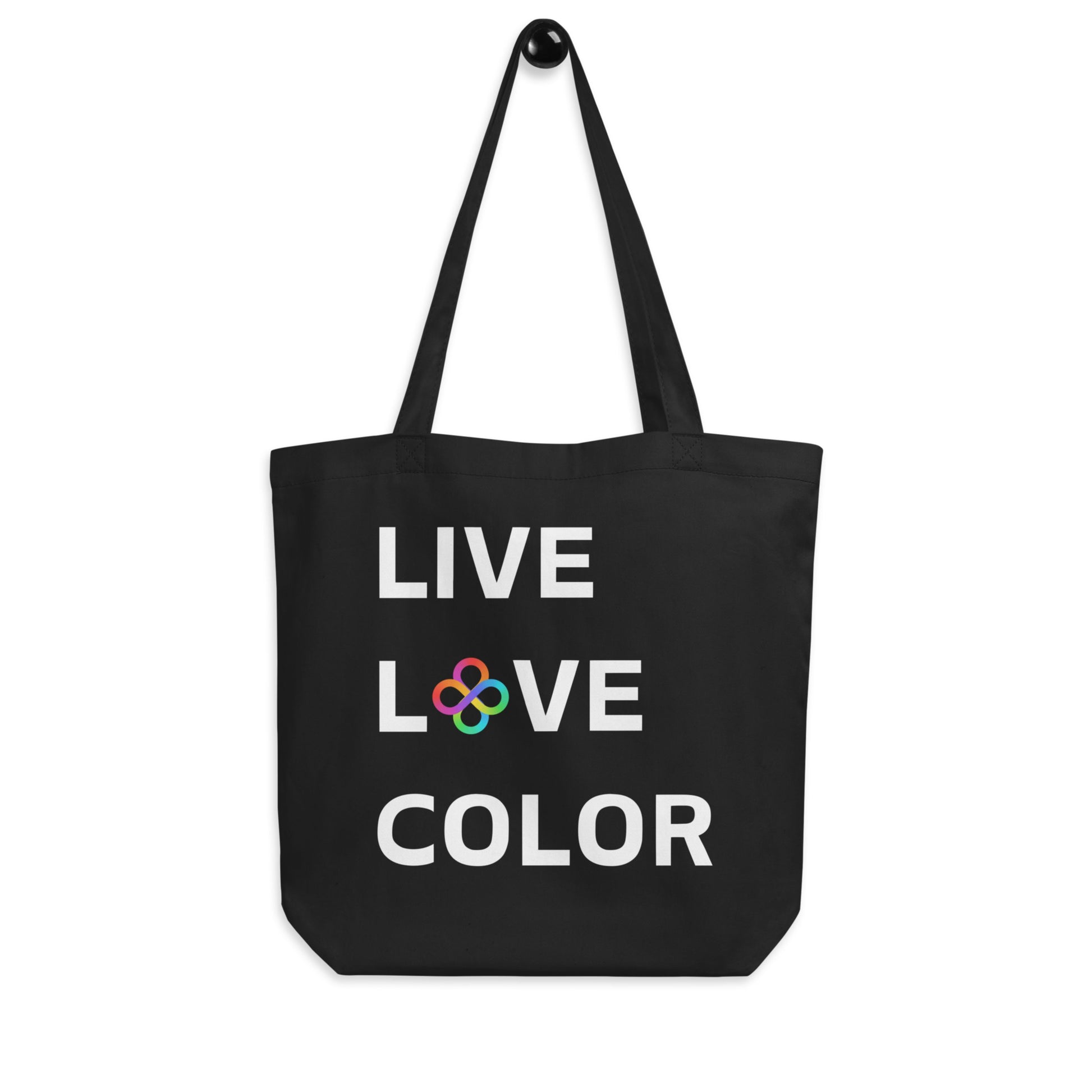 Black canvas tote bag with white bold print that says LIVE LOVE COLOR. The letter O in the word LOVE has been replaced with rainbow infinity symbols.