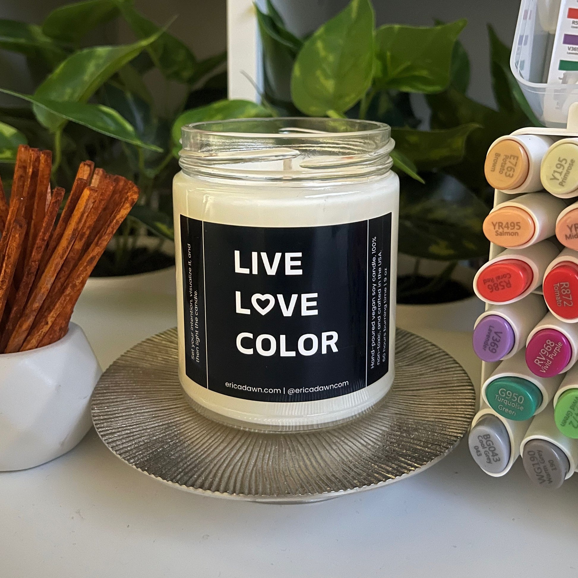 Hand-poured vegan soy wax candle. Soy wax inside a glass jar, a single cotton wick, with an outside label that says LIVE LOVE COLOR, with a screw top lid. The letter O in the word LOVE has been replaced with a heart symbol.