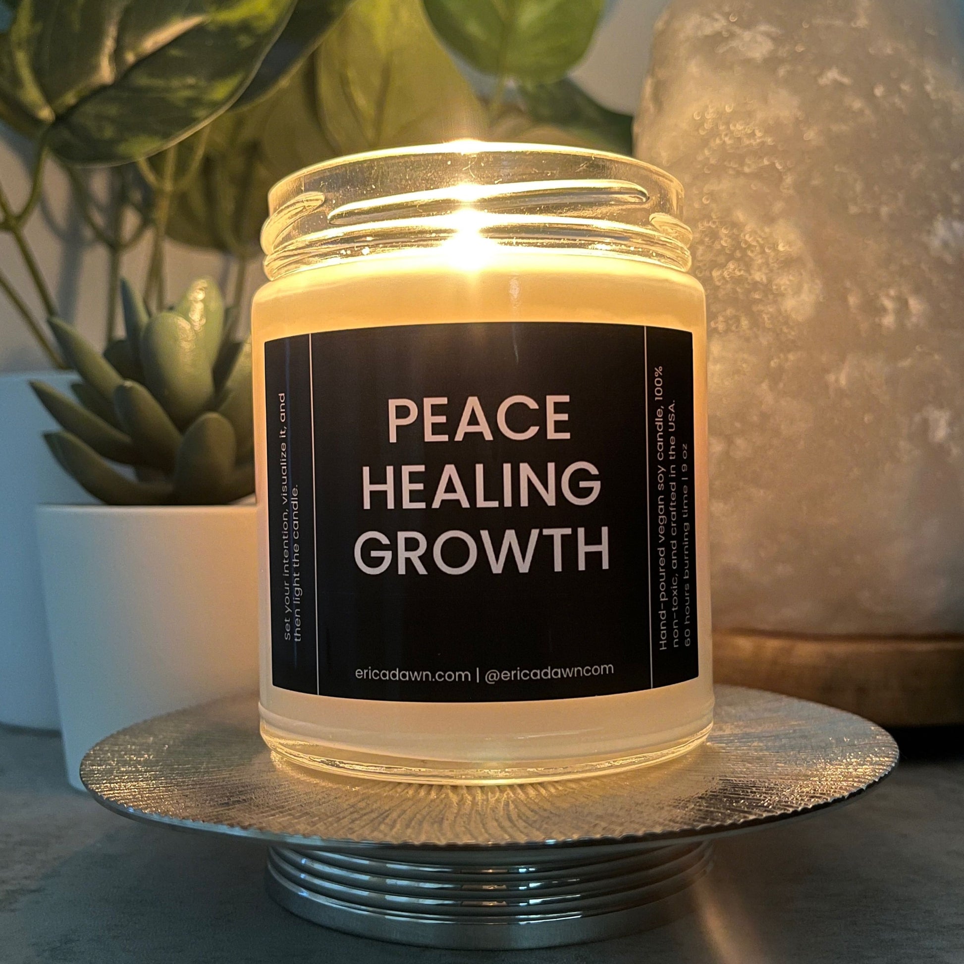 Hand-poured vegan soy wax candle. Soy wax inside a glass jar, a single cotton wick, with a black and white outside label that says PEACE HEALING GROWTH, with a screw top lid.