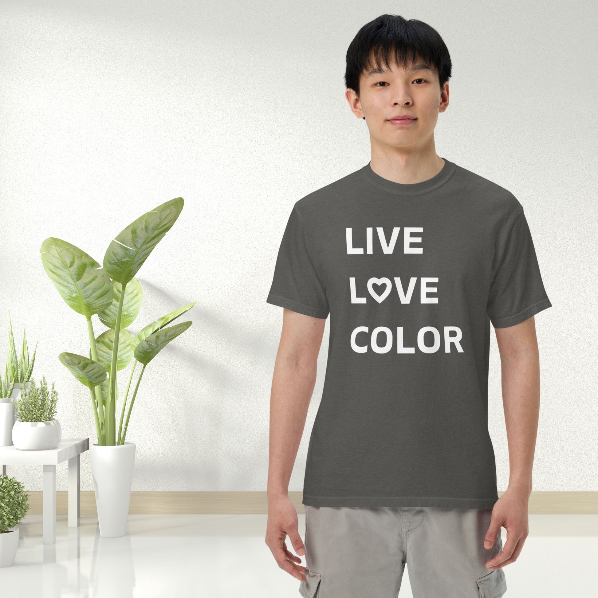 Pepper color T-Shirt with white bold print that says LIVE LOVE COLOR. The letter O in the word LOVE has been replaced with a heart symbol.