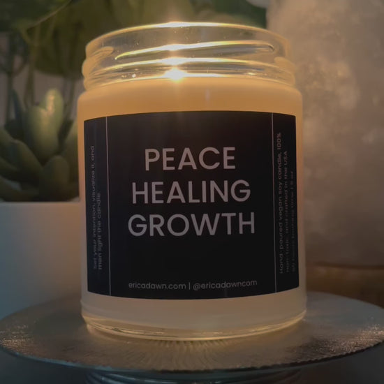 Hand-poured vegan soy wax candle. Soy wax inside a glass jar, a single cotton wick, with a black and white outside label that says PEACE HEALING GROWTH, with a screw top lid.