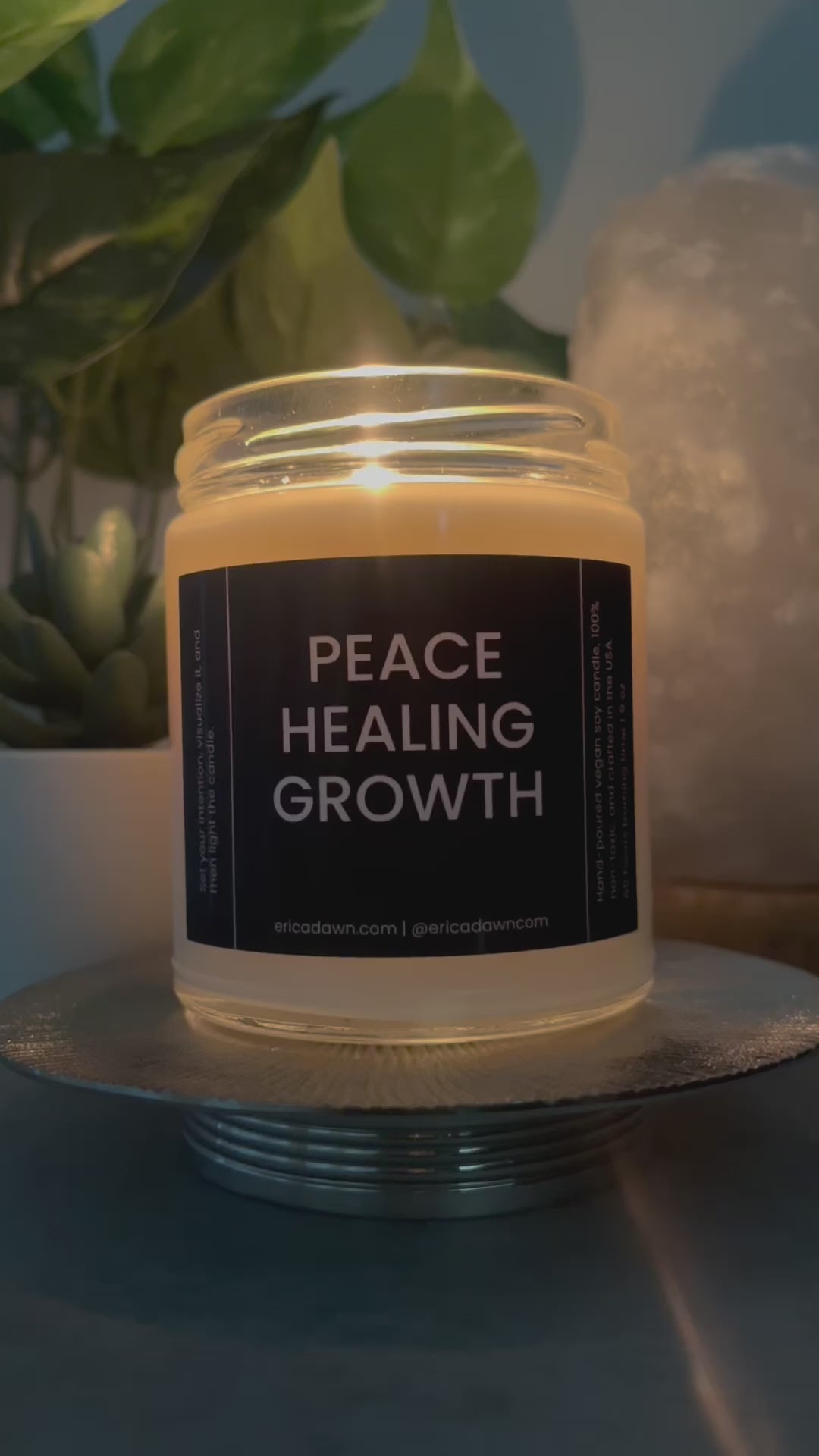 Hand-poured vegan soy wax candle. Soy wax inside a glass jar, a single cotton wick, with a black and white outside label that says PEACE HEALING GROWTH, with a screw top lid.